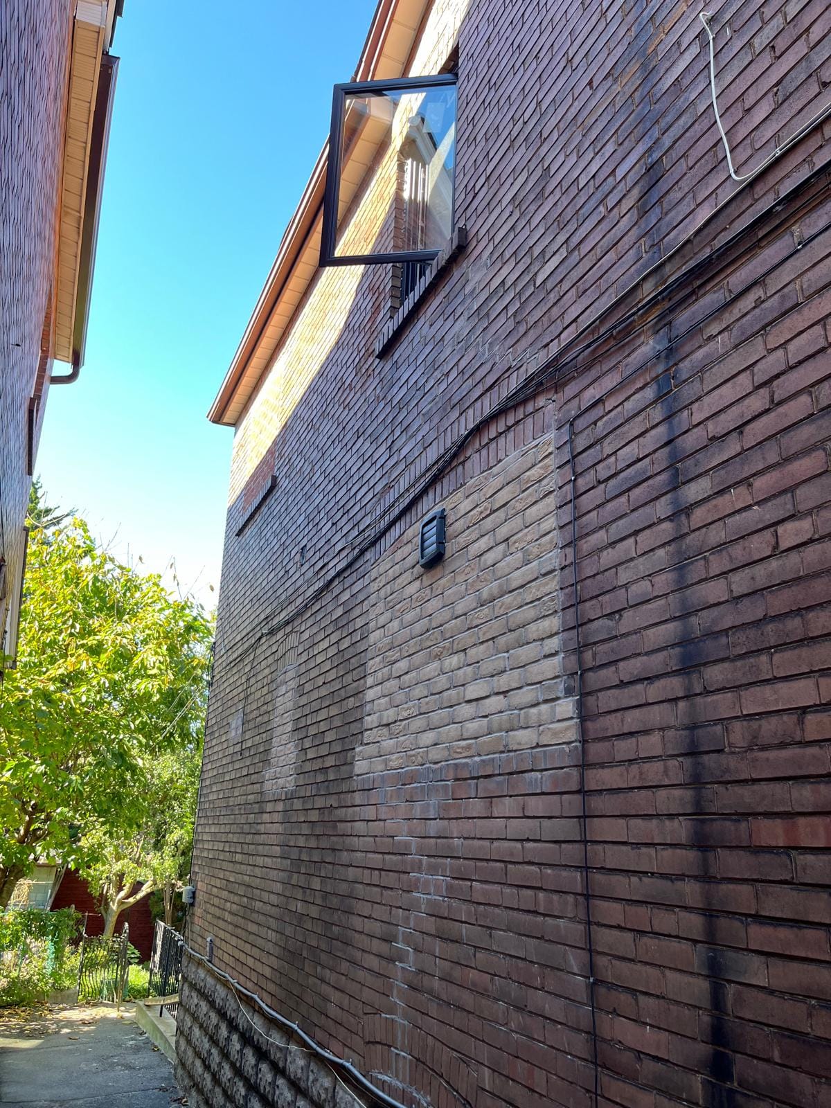 Side view of residential house with a bricked-up window