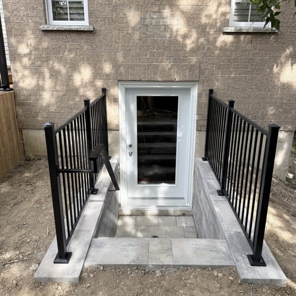 New basement walkout door cut with railing and stairs, Keswick