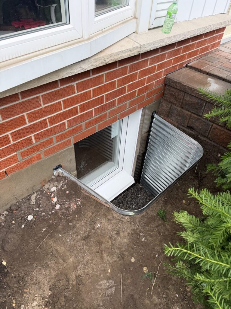 Finished egress window after a cut-down, with galvanized steel window well, Oshawa
